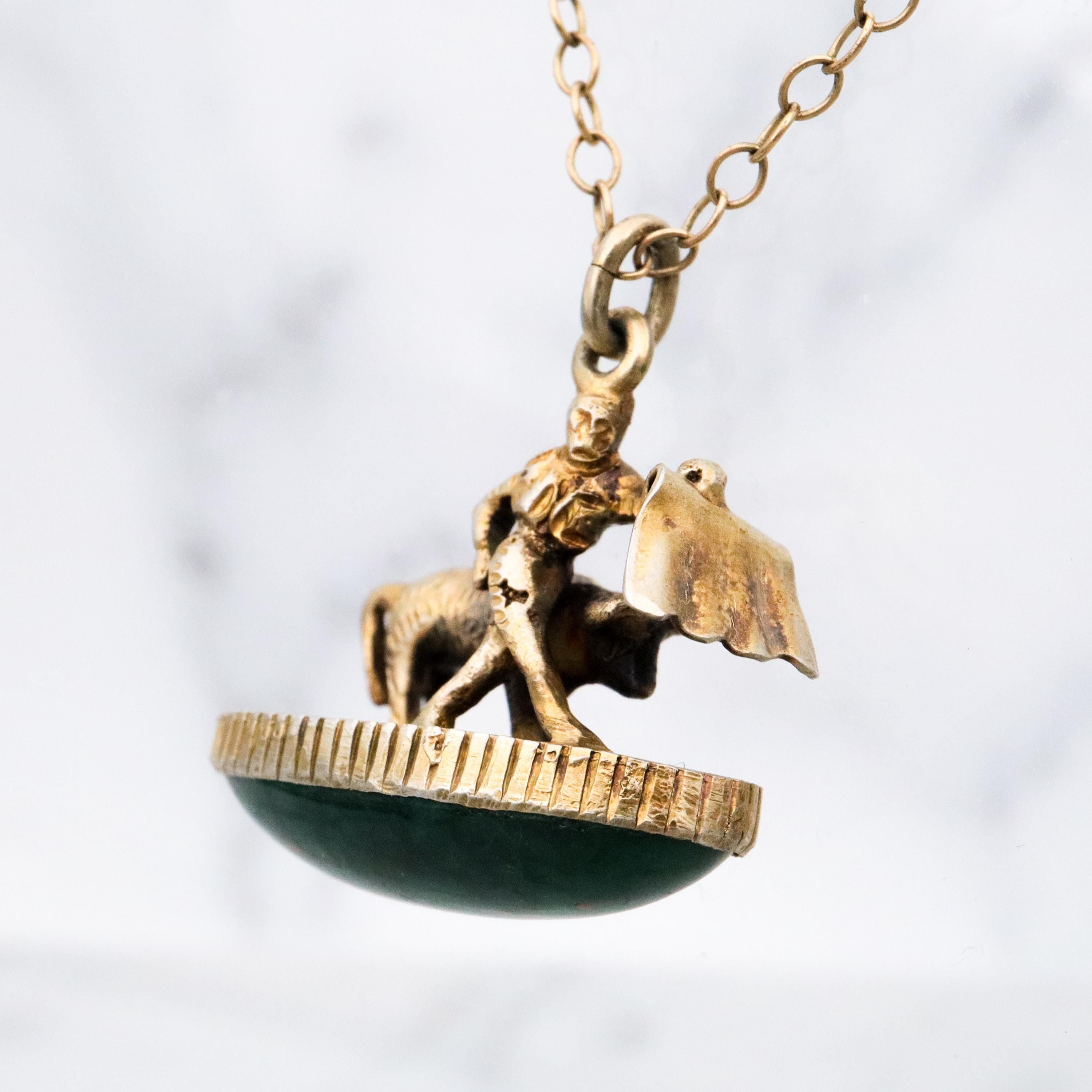 Antique gilt sterling figural matador & bull fob pendant w/faux bloodstone bottom