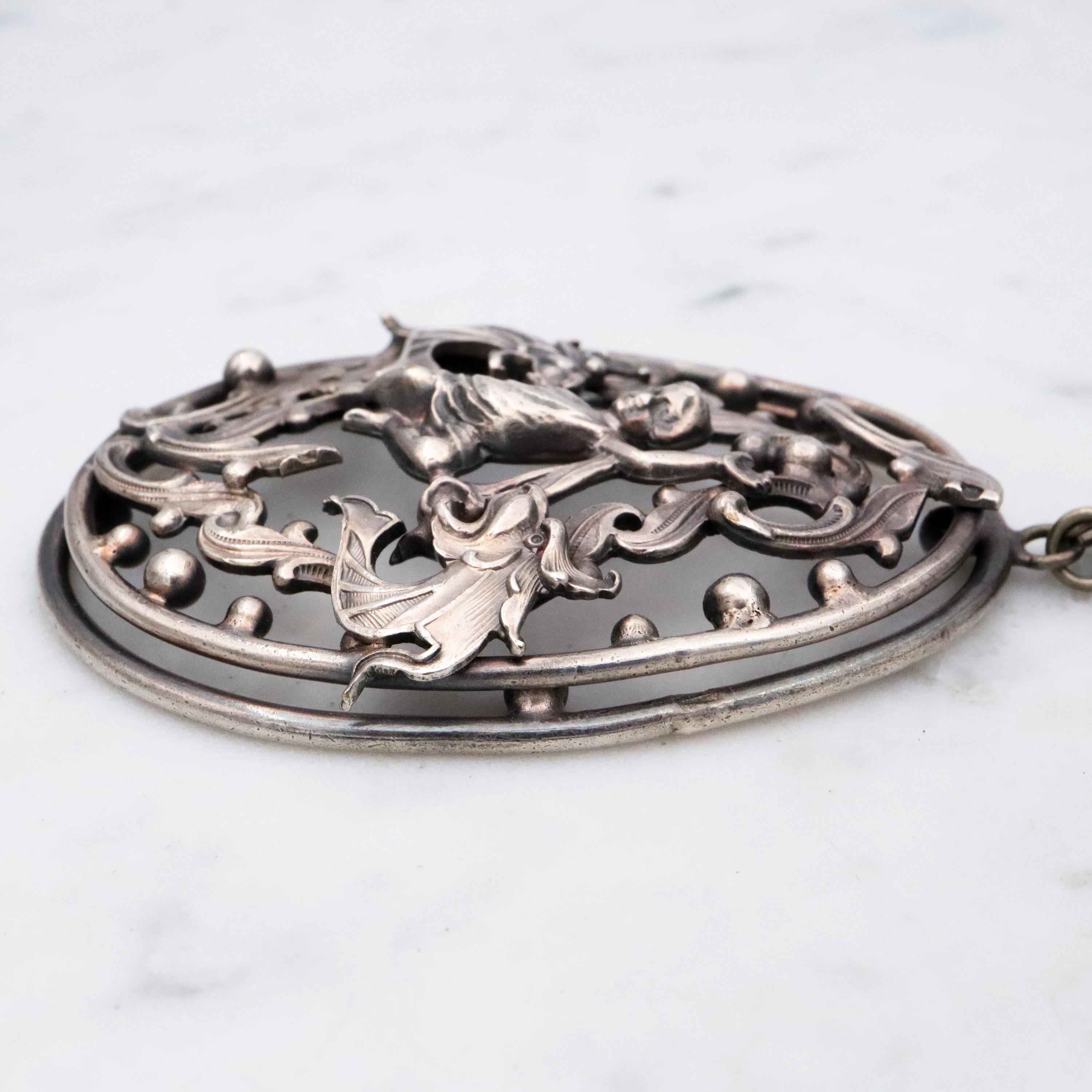Antique Renaissance Revival silver plated putti & dragon cutout pendant necklace