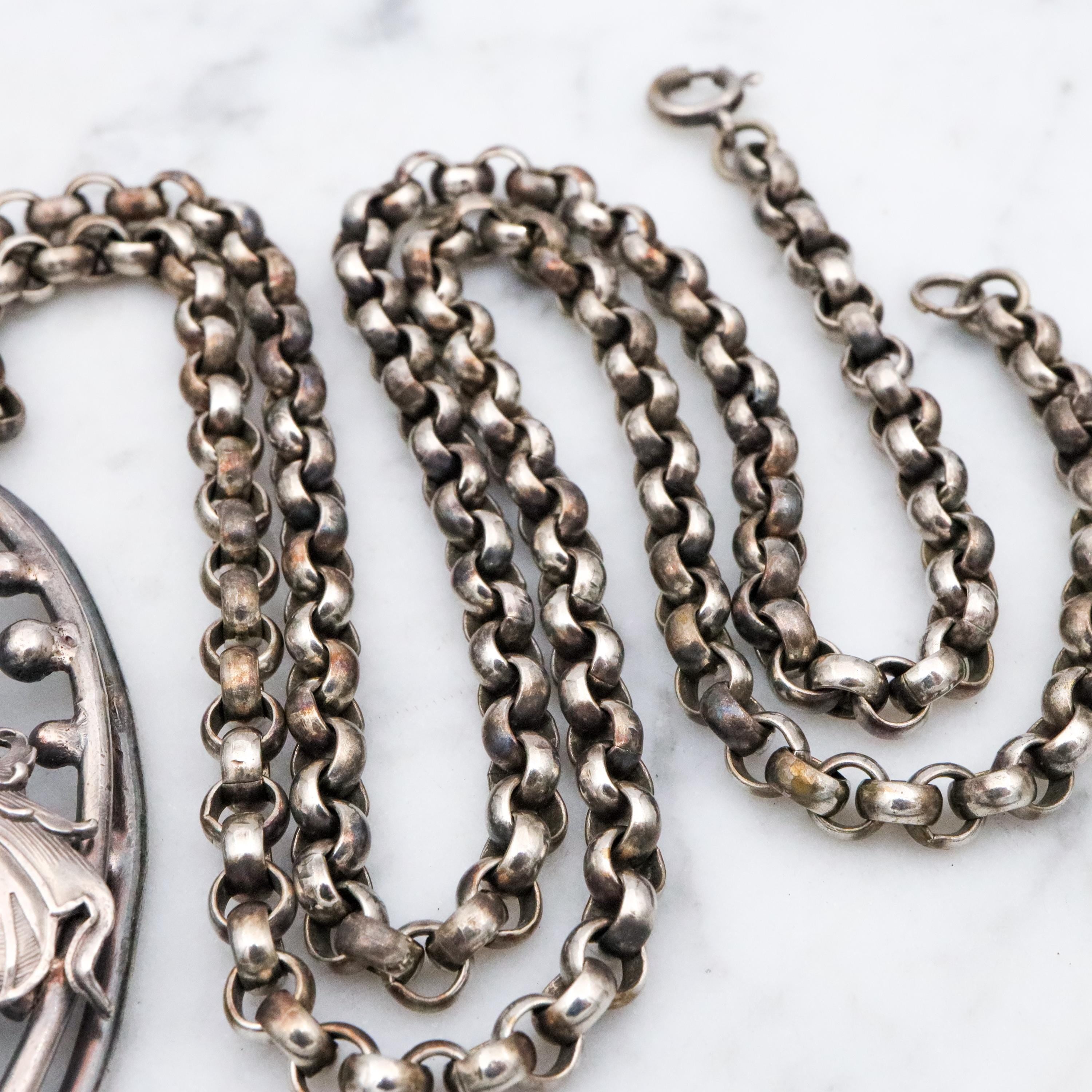 Antique Renaissance Revival silver plated putti & dragon cutout pendant necklace