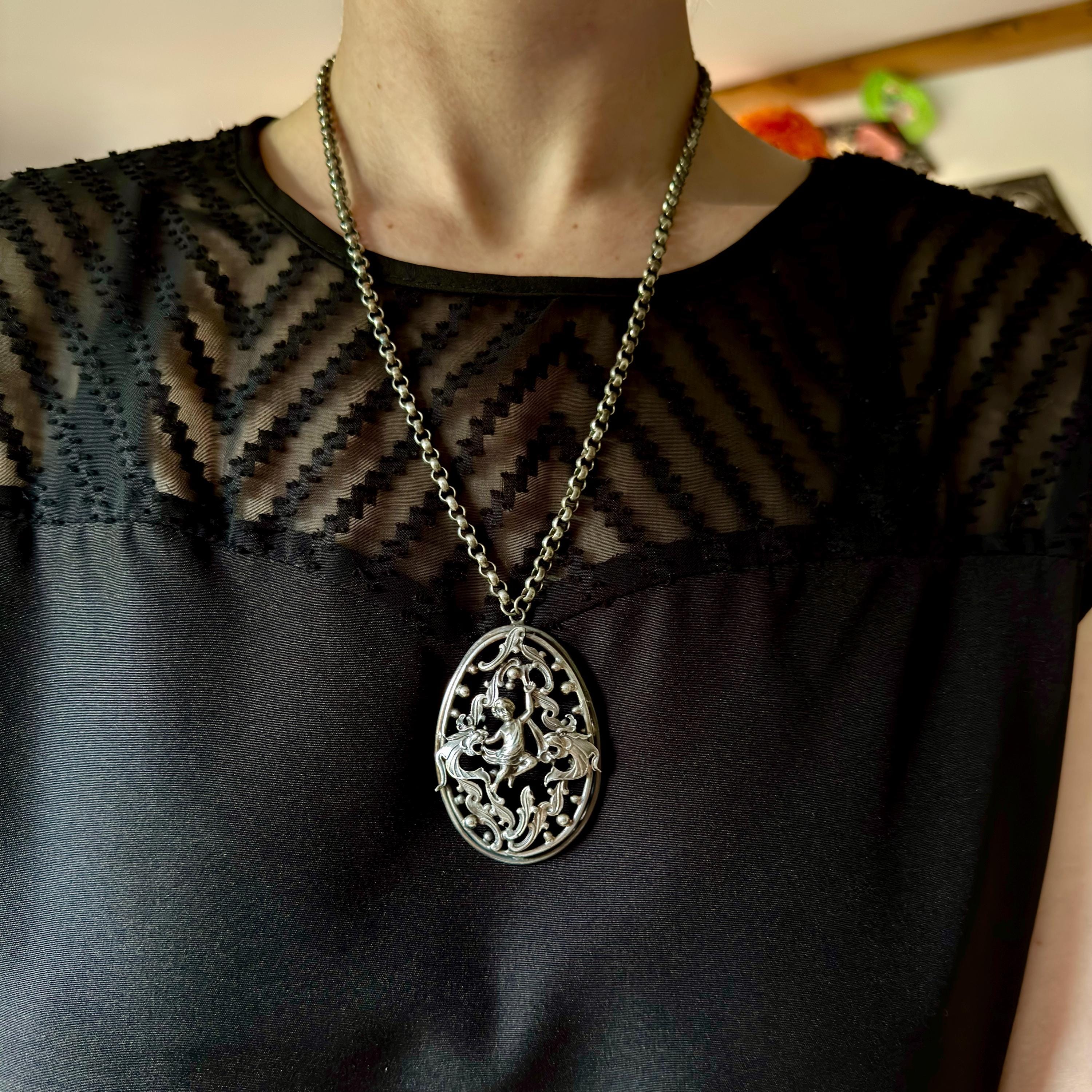 Antique Renaissance Revival silver plated putti & dragon cutout pendant necklace