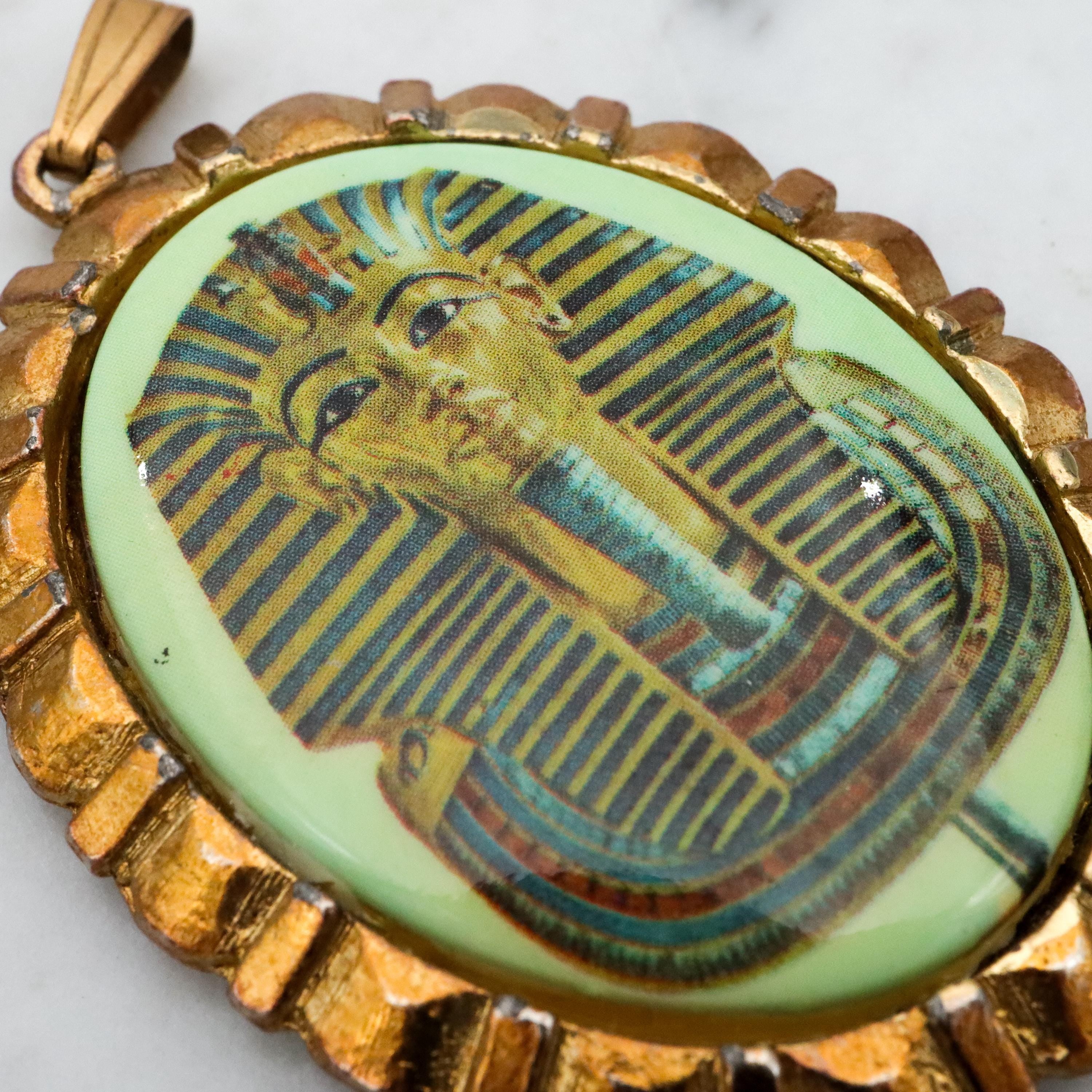 Mid Century gold tone & green glass Egyptian Revival plaque pendant