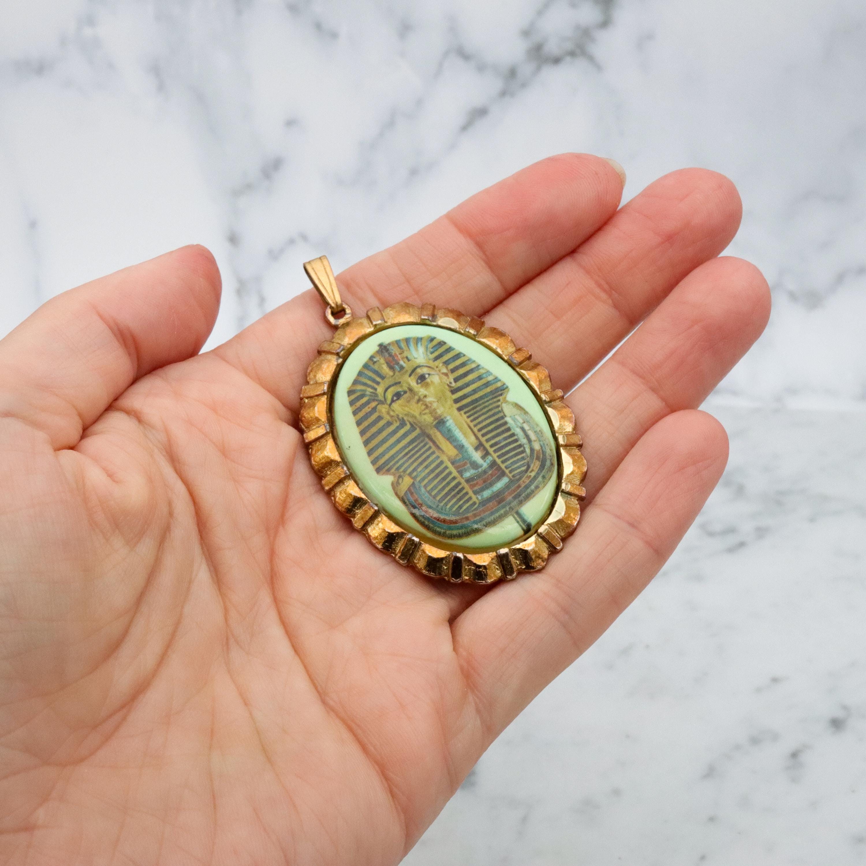 Mid Century gold tone & green glass Egyptian Revival plaque pendant