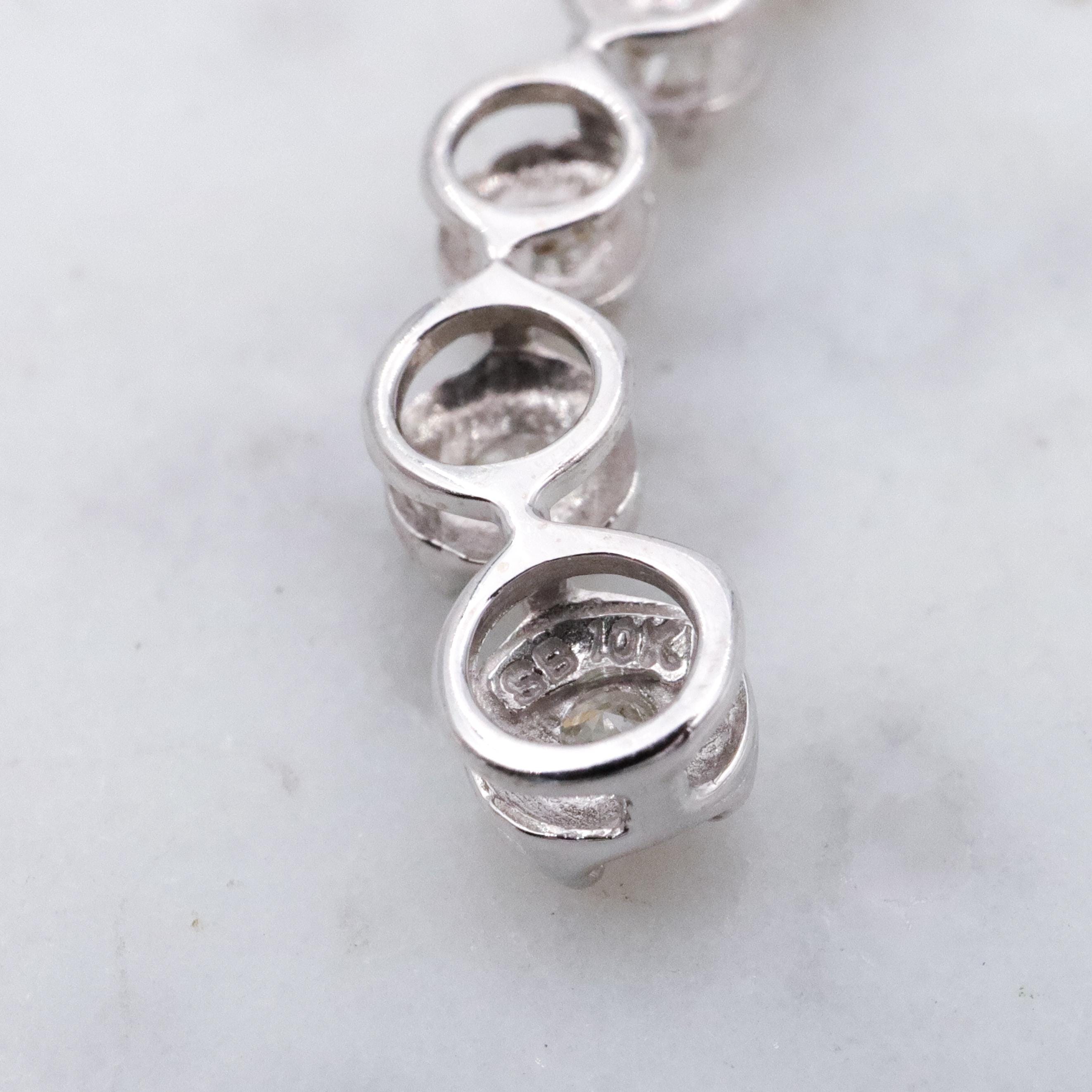 Vintage 10k white gold diamond graduated S-curve journey pendant